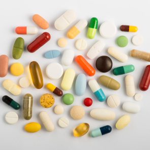 vitamins and supplements pills overhead studio gray background