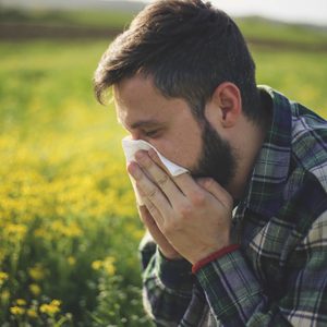 man reacting to spring allergies