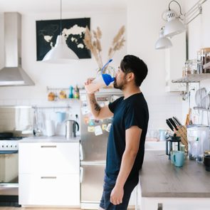 fitness vlogger drinks protein shake after home workout