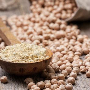 Chickpea flour in a wooden spoon