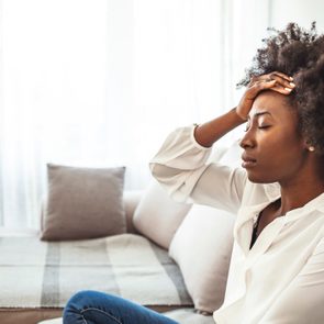 Shot of a young woman suffering from a headache.