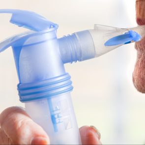 Close Up Of Elderly Man Using Nebulizer