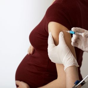 pregnant woman getting a vaccine shot