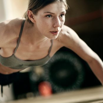 Focused female boxer doing push-ups