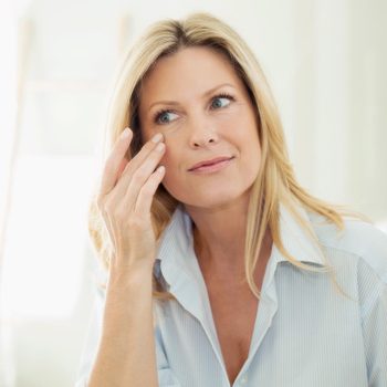 Portrait of woman looking at her mirror image in the morning