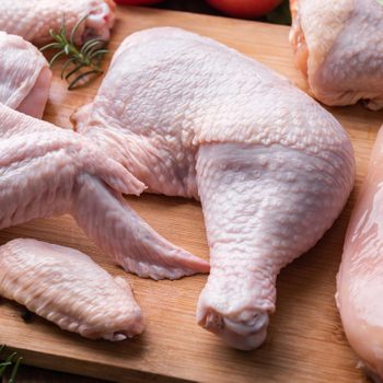 Raw chicken cuts on a cutting board